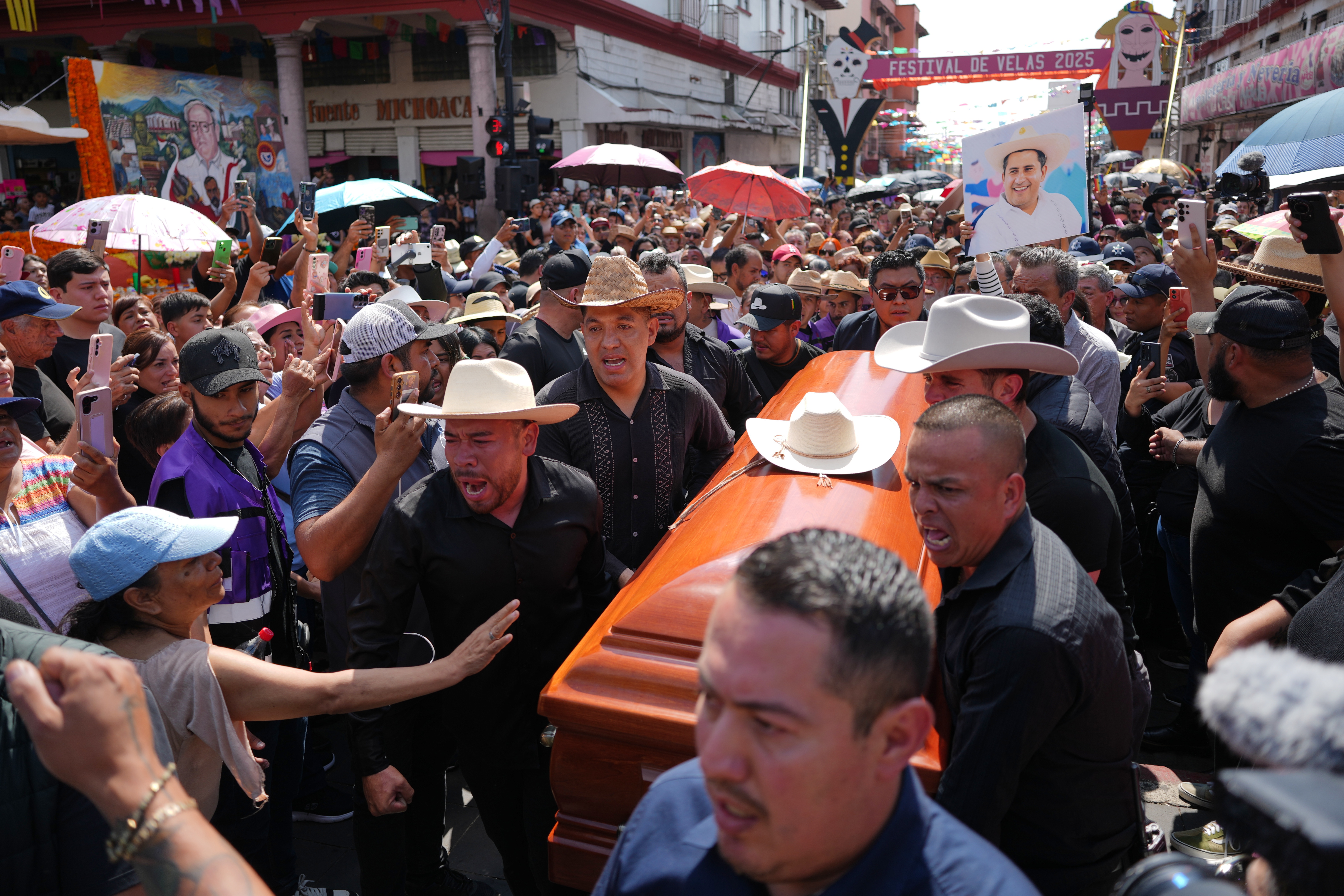 People carry the coffin of late Mayor Carlos Alberto Manzo Rodríguez, who was shot during Day of the Dead celebrations, in Uruapan, Michoacan state, Mexico, Sunday, Nov. 2, 2025.